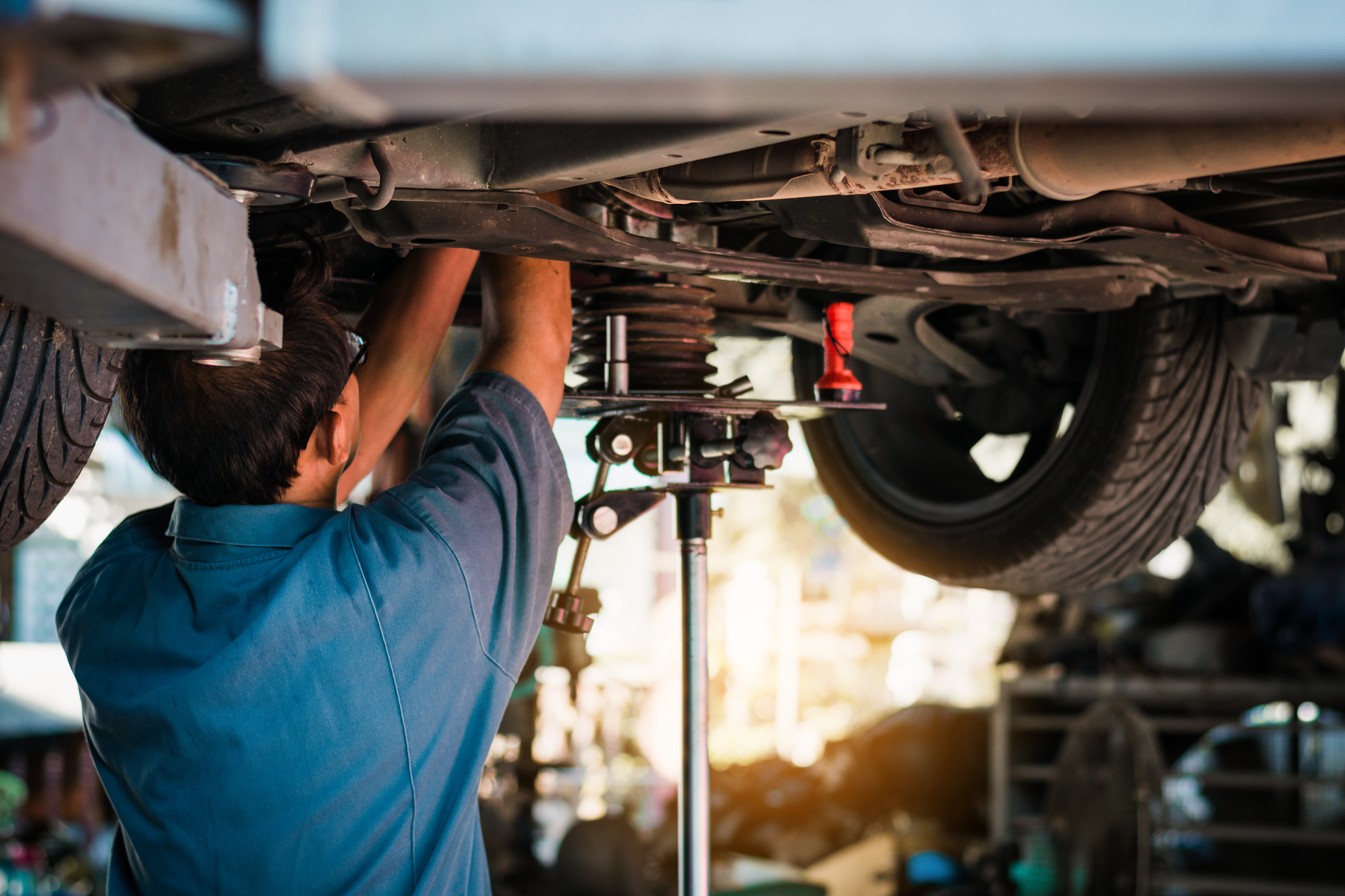 Certified technician inspecting a car engine