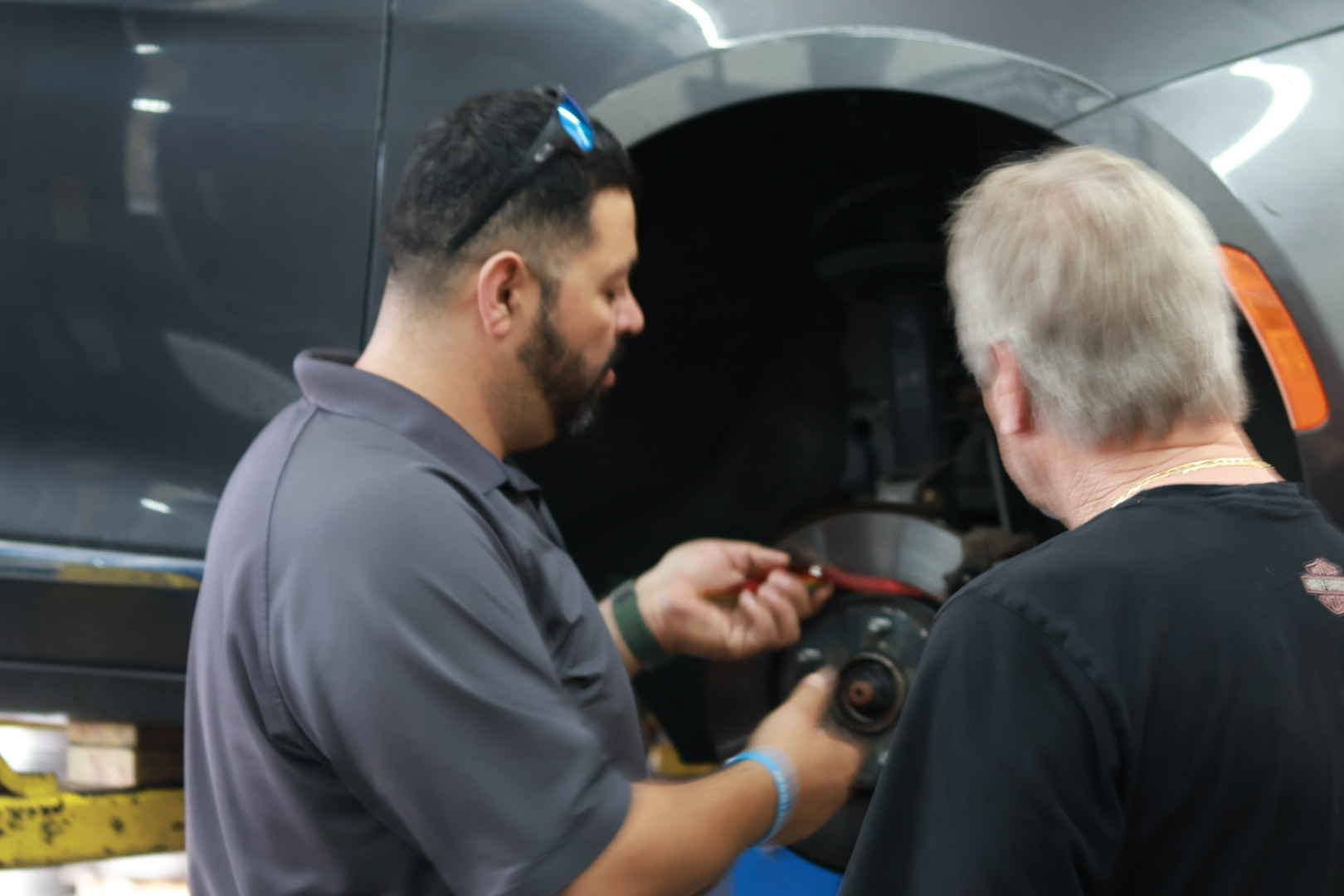 Technician performing a comprehensive brake inspection on a vehicle