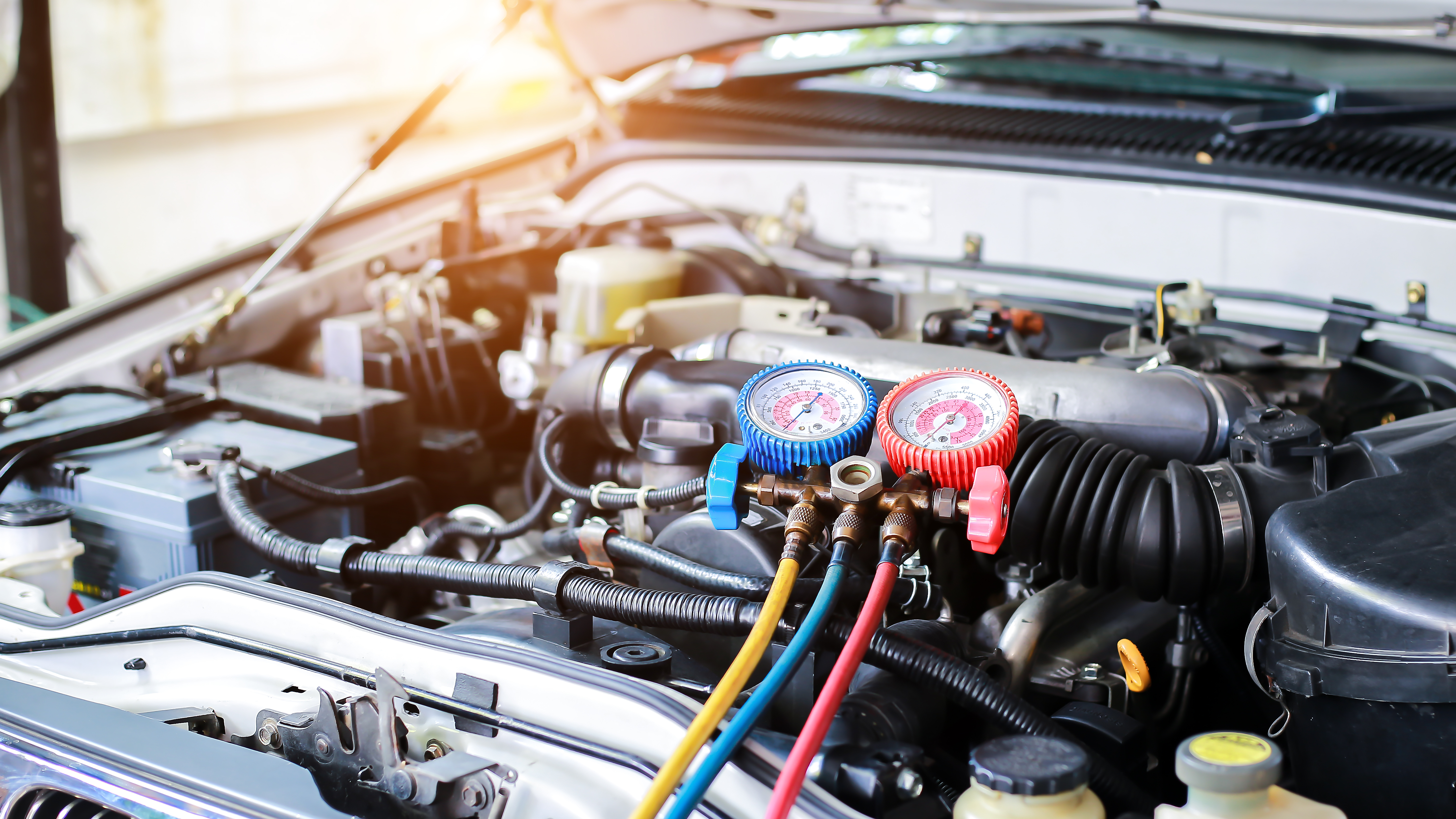 Mechanic inspecting vehicle components