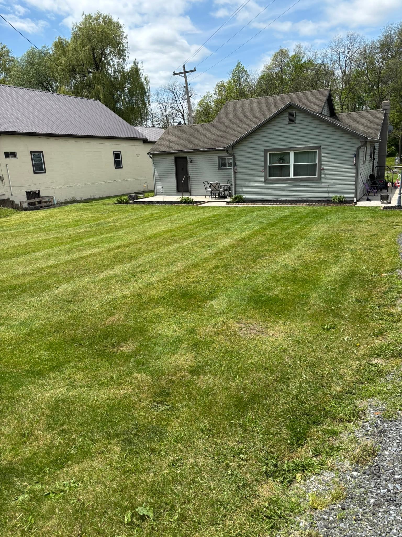 Lawn care technician mowing a residential yard