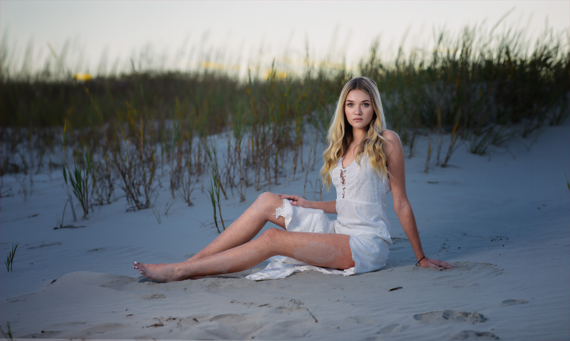 Senior model sitting in a field with flowers