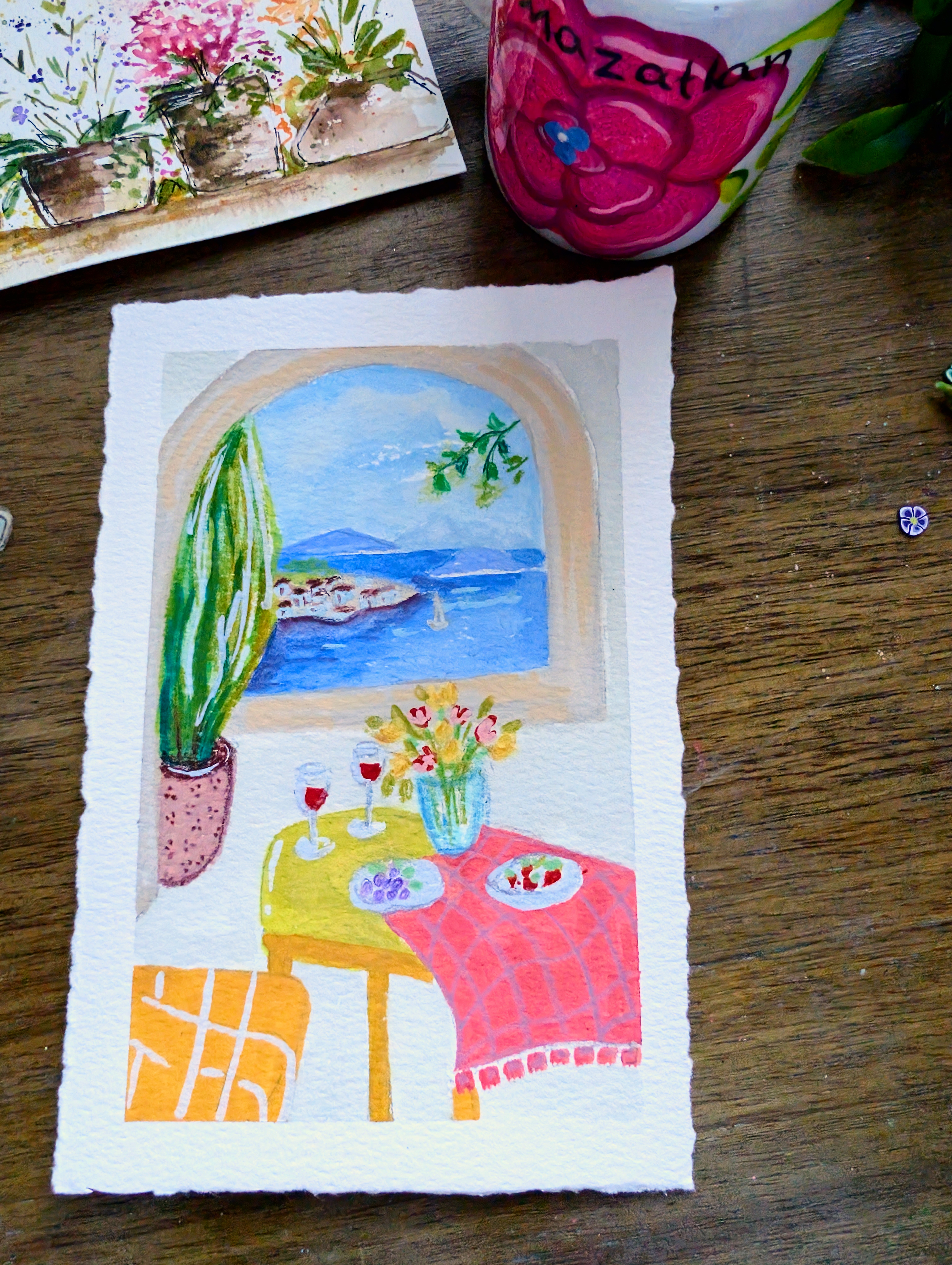 A watercolor painting of a red mushroom with white spots in a sketchbook
