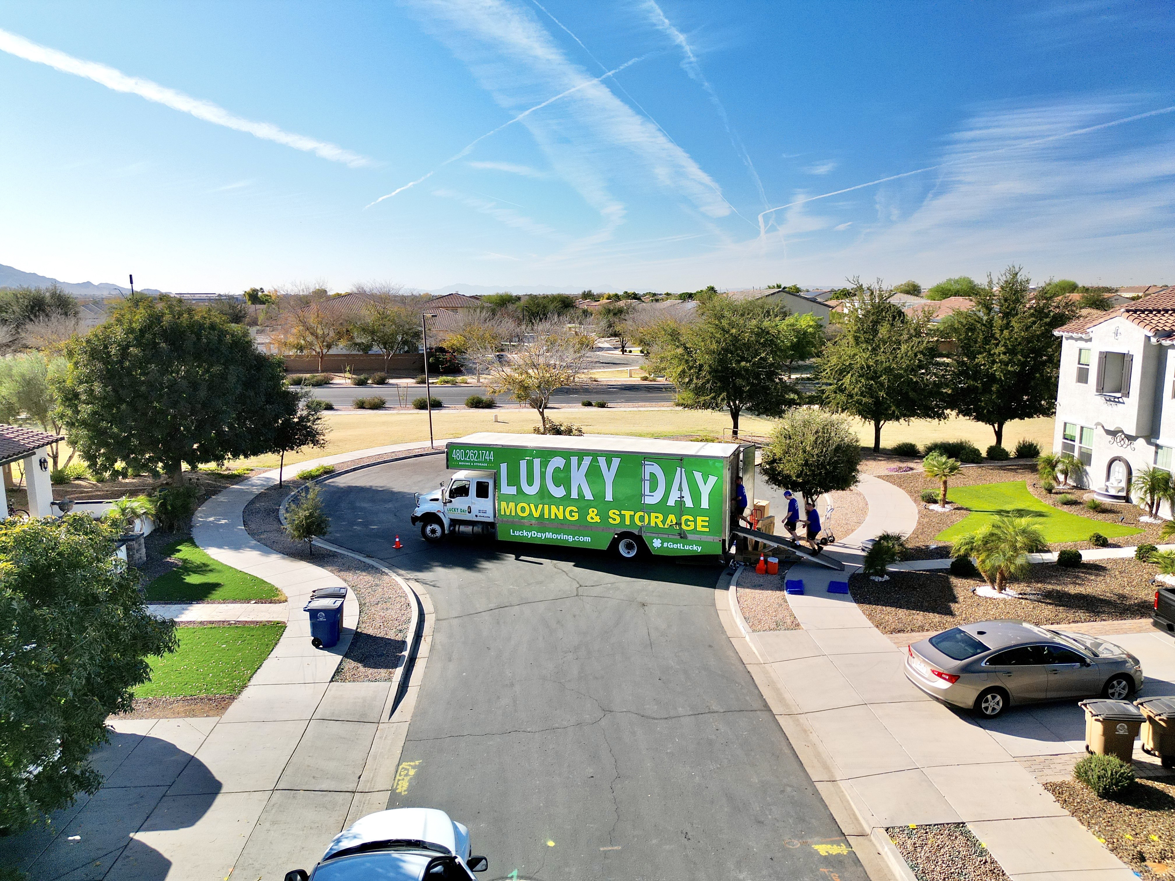 Lucky Day Moving crew member unloading boxes from a moving truck