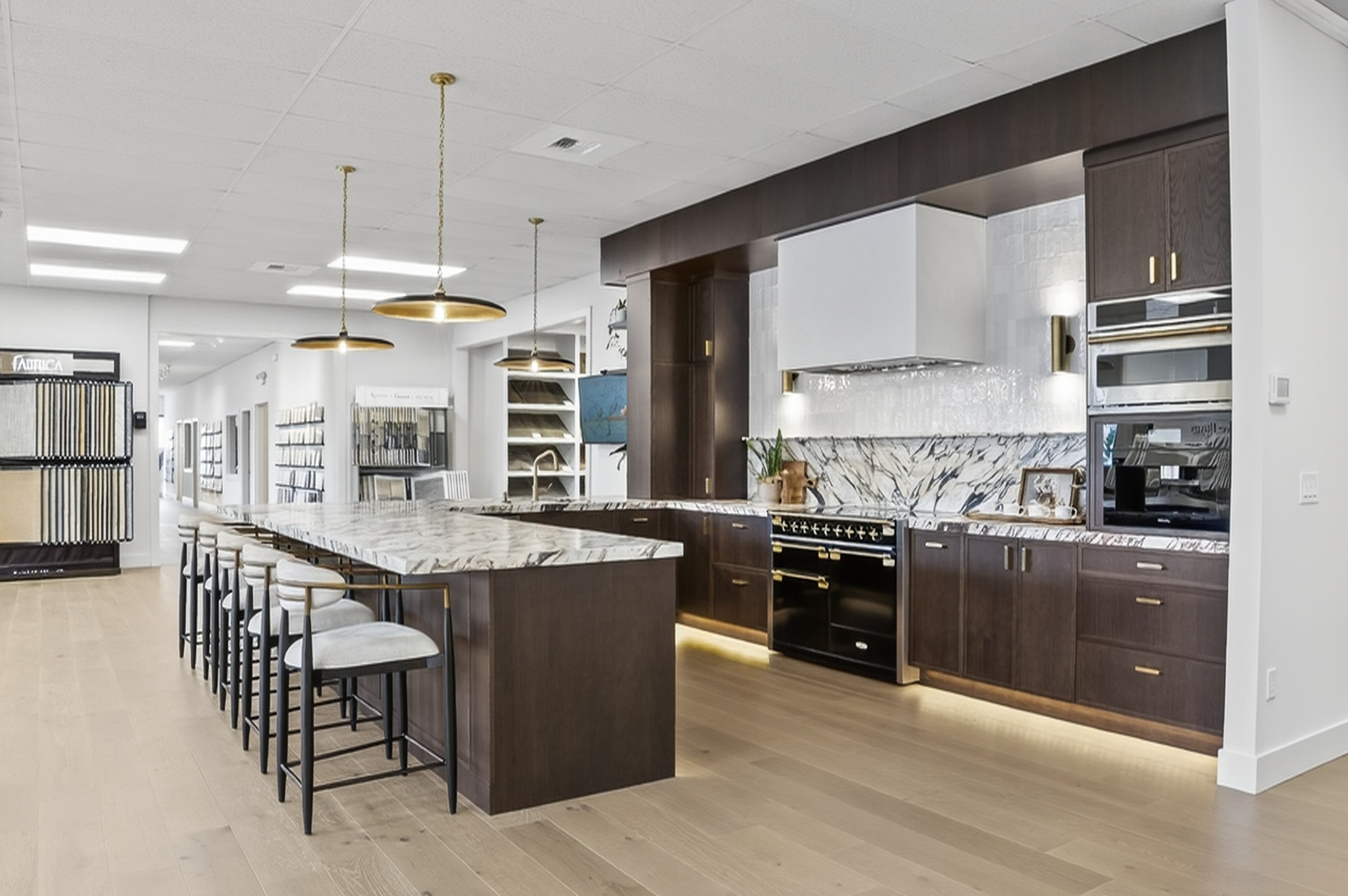 CR Floors showroom — open kitchen vignette with island and cabinetry