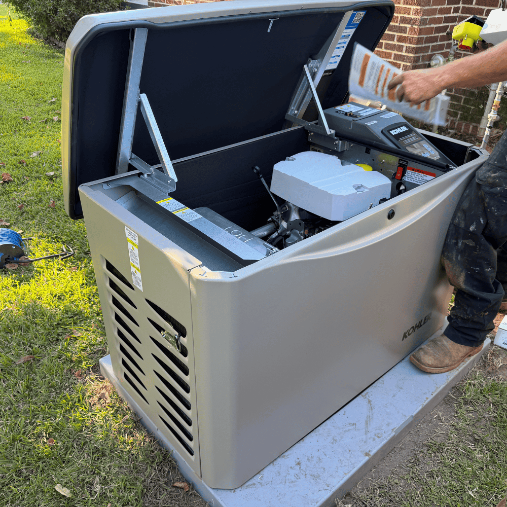 Technician installing a standby generator system at a home