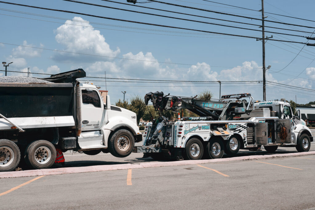 A white tow truck parked and ready for commercial fleet service