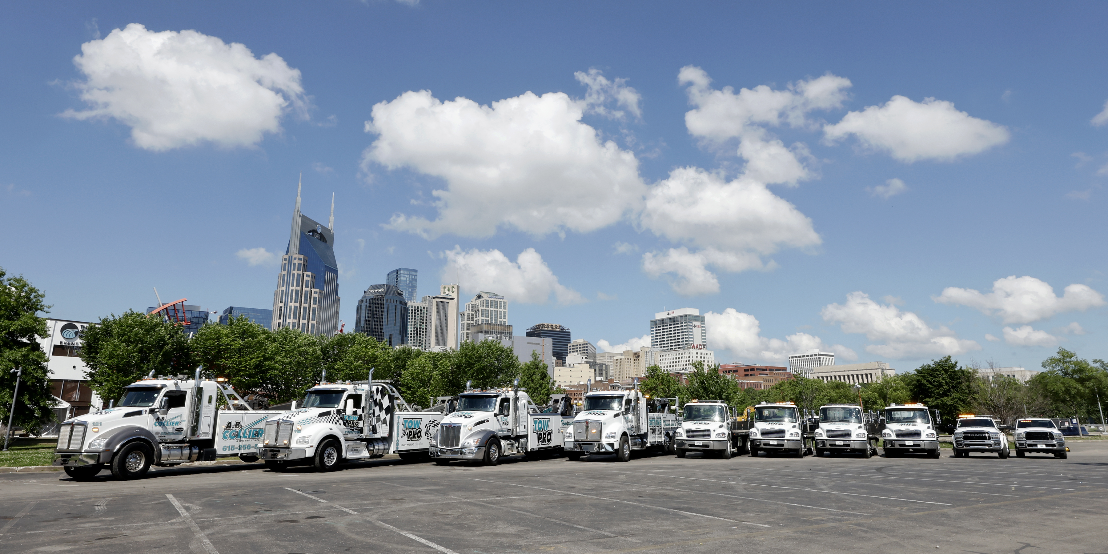 Tow Pro regional fleet — semi trucks and heavy tow vehicles staged at a Tennessee yard