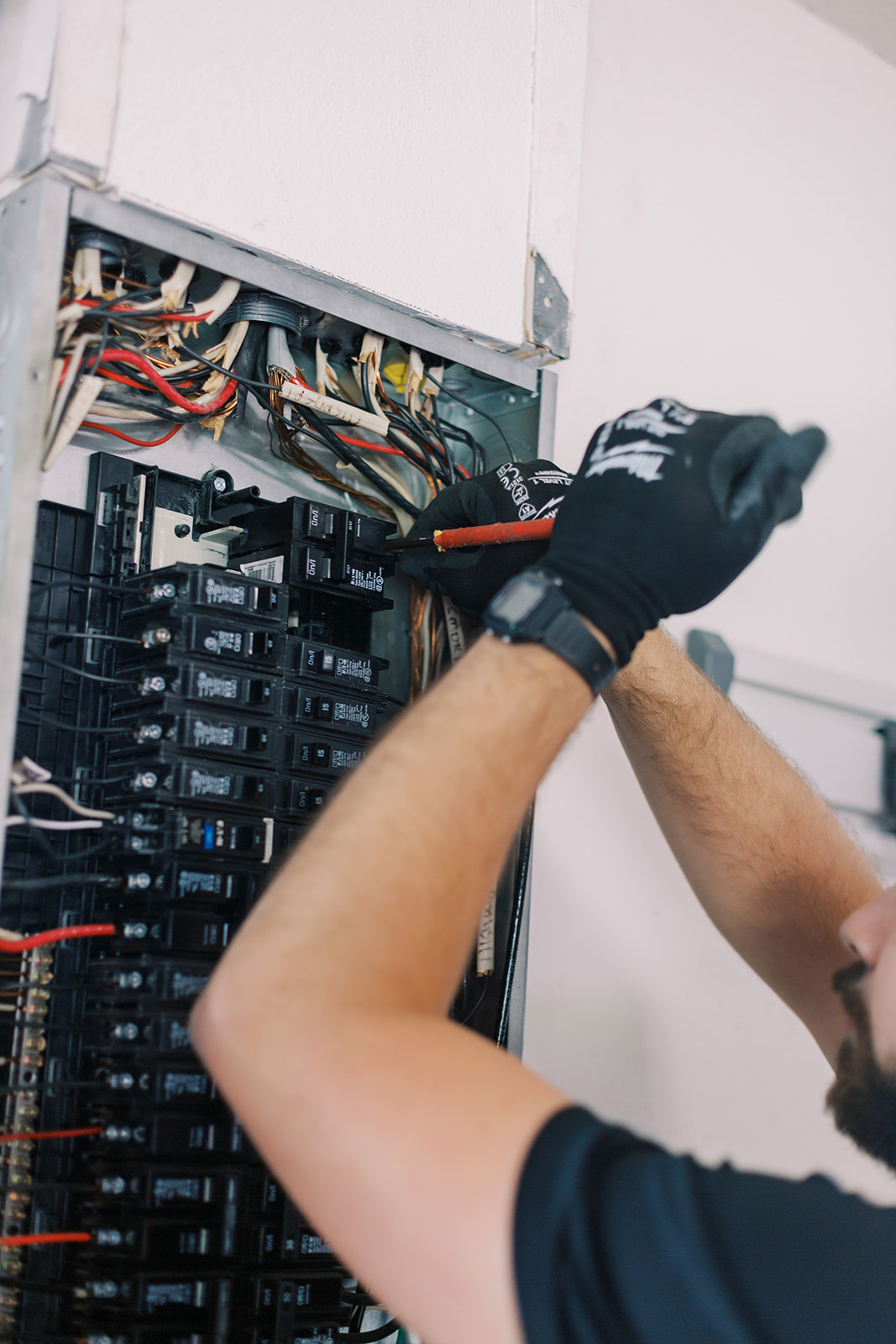Licensed electrician working on residential electrical panel upgrade