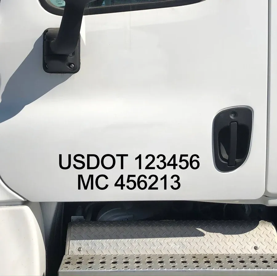 White truck door displaying USDOT and MC numbers.