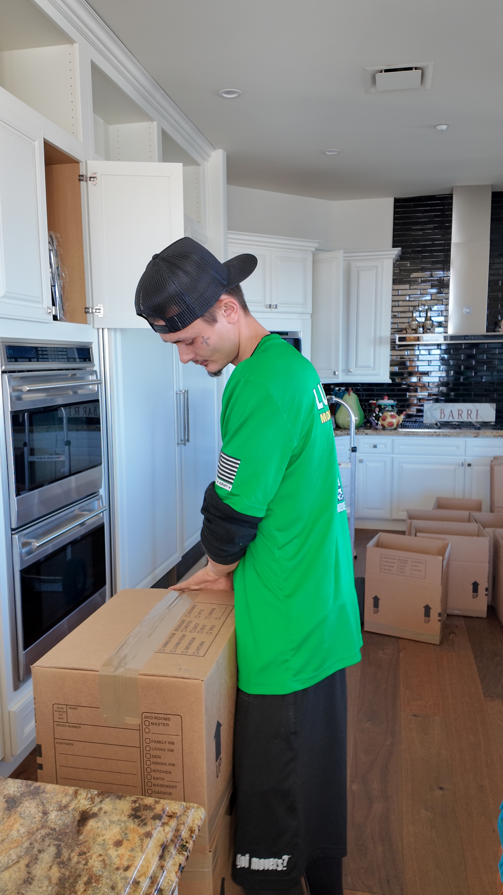 Mover loading boxes from a truck onto a dolly — East Valley moving service