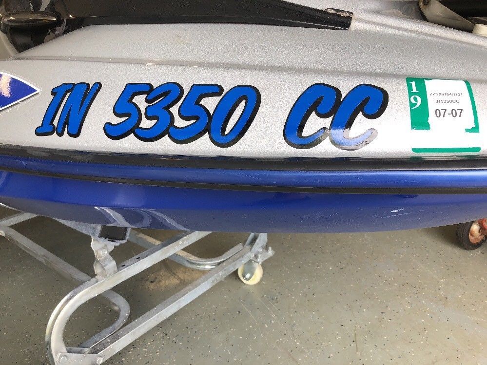 Boat registration number decals on hull
