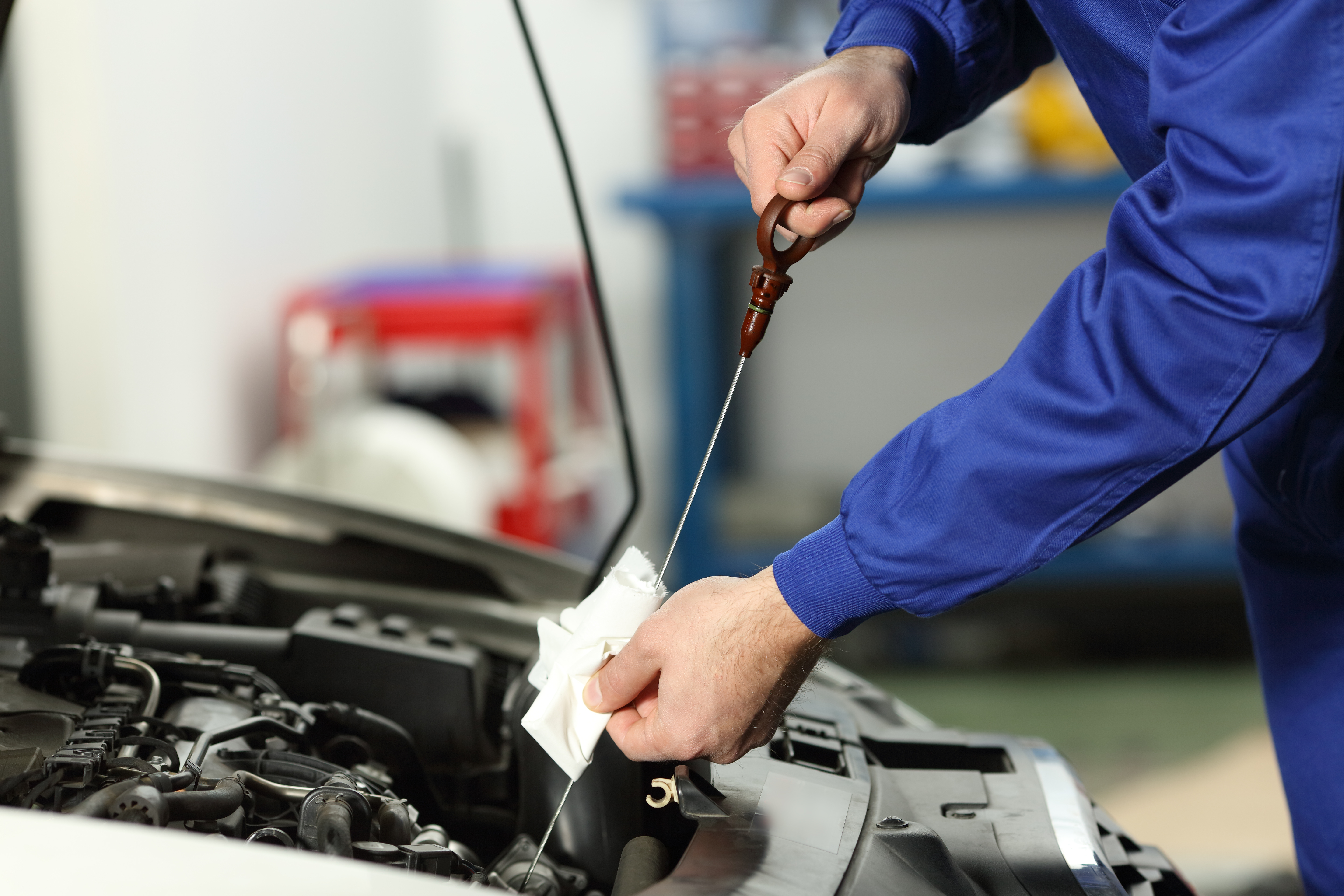 Mechanic performing an oil change on a vehicle