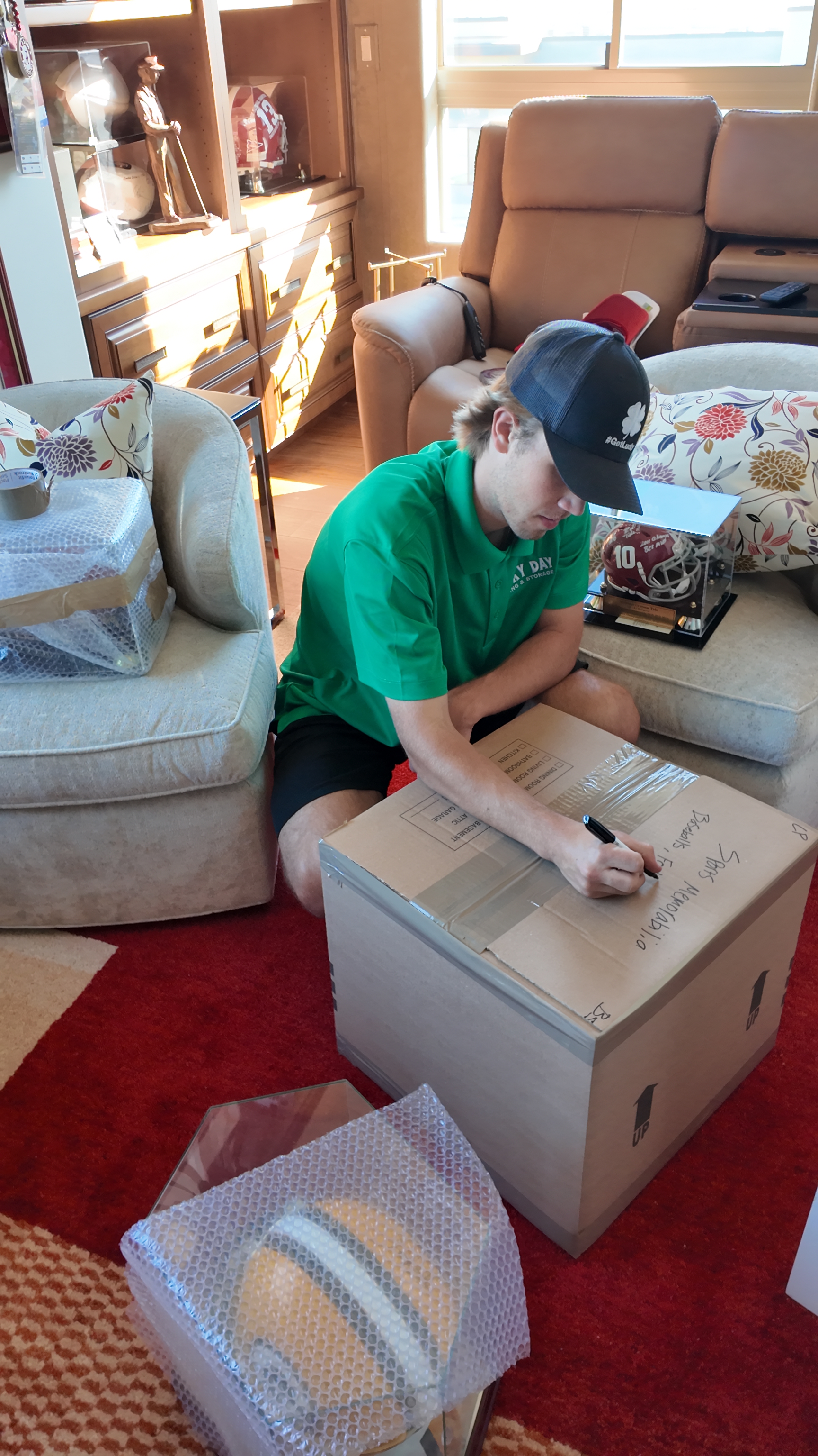 Lucky Day Moving crew unloading furniture from a moving truck with safety gear visible